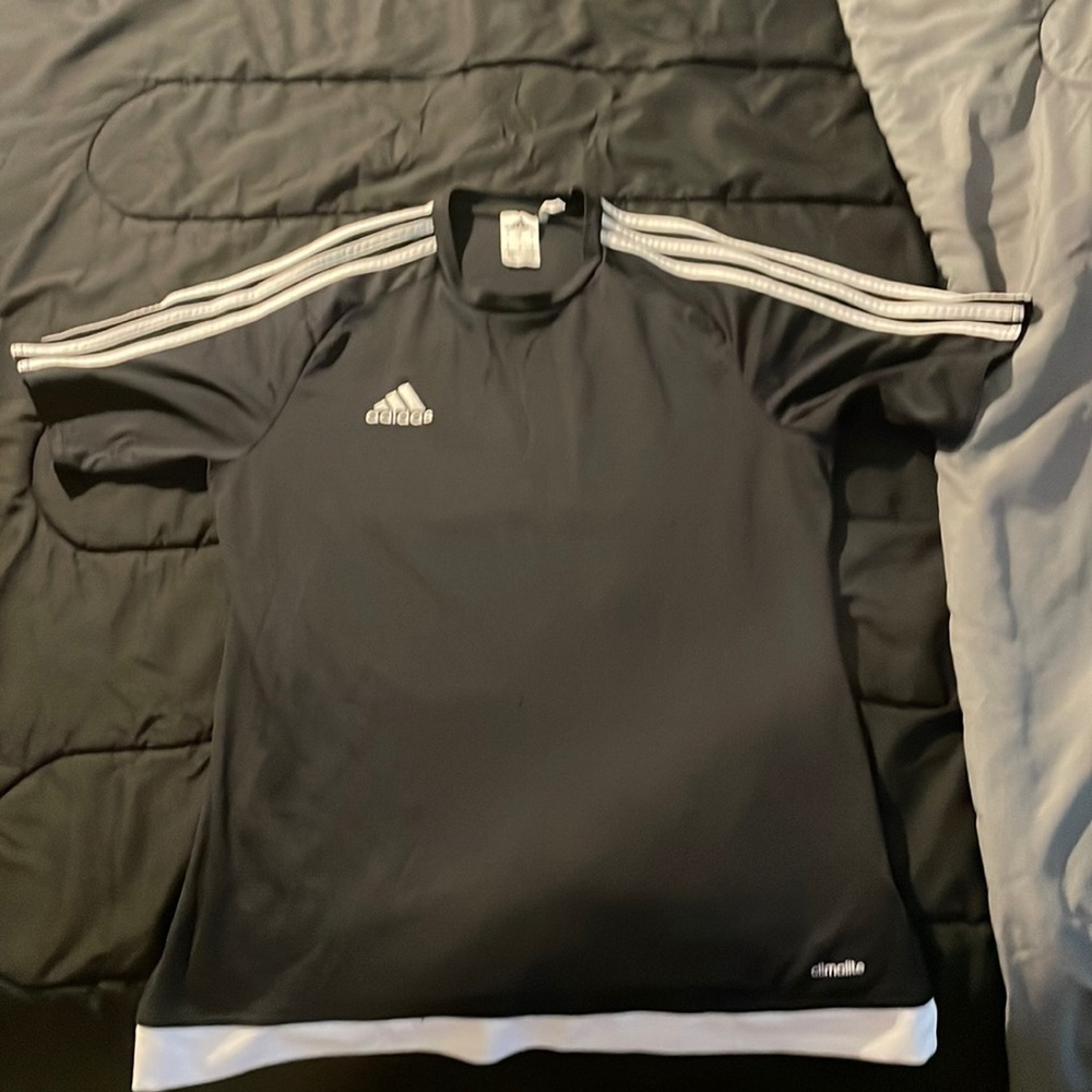 2 red and black adidas shirts with stripes